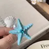 Pinza para el pelo con forma de estrella de mar y concha de perla, estilo resort costero, incrustada de diamantes, sensación de lujo ligero y alta gama, accesorio de moda para el cabello para mujer