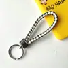 Llavero creativo de cuerda de cuero tejido a mano para pareja, llavero de coche, llavero al por mayor, colgante para bolso