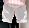 Ropa infantil coreana 2026 primavera y otoño nuevo conjunto de suéter de punto con cuello polo a rayas rosas y pantalones casuales blancos