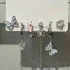 Grl legal! Conjunto de seis peças de brincos com borla de borboleta escura, brincos de design de nicho, brincos de fivela de orelha