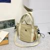 Bolso de tela de nailon para comercio exterior para mujer en verano, versátil 2025 nueva moda popular bandolera bolso pequeño bolso de tela bolso cubo