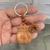 Llavero de imitación de madera de durazno colgante de bolsa de madera tallada puesto de mercancía pequeña colgante de llave de coche al por mayor una generación de cabello