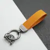 Colgante Llavero de Coche de Cuero Gamuzado Anillo de Resorte de Aleación de Zinc Cubierta de Llave Cadena de Llave con Logo de Coche Venta al por Mayor