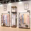 Perchero moderno simple de piso estante multicapa simple estante para ropa de mujer soporte de exhibición de ropa de hierro venta al por mayor