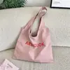 46203 Bolso de hombro tipo tote rosa claro con estampado de letras estilo coreano, bolsa de lona de gran capacidad para estudiantes y para ir al trabajo, bolso de lona versátil
