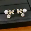 Aretes de clip de perla con mariposa tachonados de circonia para mujeres sin perforaciones, aretes exquisitos y versátiles con un toque de lujo ligero y alta gama, venta al por mayor