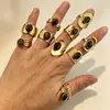 Anillo de acero inoxidable bañado en oro estilo europeo y americano con piedra ojo de tigre, una pieza de joyería lujosa y de alta gama con piedra ojo de tigre natural y acero de titanio, diseñado para ser duradero y resistente a la decoloración