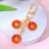 Estilo Ins Flor de Margarita con Goteo de Aceite Borla Llavero Creativo Colgante para Bolsa de Auriculares de Niñas Venta Caliente