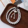 Comercio Exterior Dulce y Fresco Pequeña Fragancia Lujo Ligero Perla Artificial Corazón Cadena Doble Lanyard para Teléfono Móvil Colgante de Bolsa Colgante para Llavero