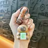 Llavero de dibujos animados creativos kappi bala de cara giratoria lindo colgante para mochila escolar llavero para llaves de coche pequeño regalo al por mayor