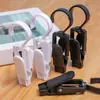 Clips plásticos multifuncionales en blanco y negro para ropa, sombreros, cortinas y calcetines, con ganchos y un diseño giratorio para un agarre fuerte