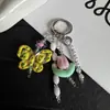 Nuevo colgante de mariposa y tulipán con cuentas ins, diseño creativo, funda para auriculares, llavero, decoración de bolso