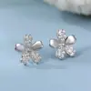 Pendientes de flor de cerezo de plata pura s999 para mujer, lujo ligero, estilo nicho de alta gama, elegantes y amigables con la oreja, nuevos pendientes versátiles