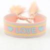 Pulsera tejida bordada con corazón de amor con borla Correa tejida ajustable Accesorios para pareja de estudiantes Venta al por mayor