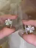 Pendientes de flor pequeña con piedra ojo de gato microincrustada para mujer 2024 nuevo estilo fresco diseño de nicho pendientes de temperamento de alta gama