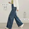 Nuevos estilos de otoño e invierno de pantalones vaqueros de pierna ancha estilo coreano para embarazadas, con líneas de corte diagonales, diseñados para ocultar el vientre, crear un efecto adelgazante y cubrir las caderas, con un diseño de longitud hasta el suelo