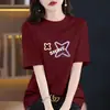 Camiseta de algodón puro de manga corta holgada de talla grande para mujer, nueva y elegante 2026, top versátil casual de nicho de longitud media