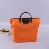 Em estoque cor sólida tecido Oxford impermeável dobrável portátil bolsa de compras portátil de viagem com zíper bolsa de armazenamento de grande capacidade