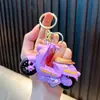 Llavero de coche cool de fricción, divertido llavero colgante de modelo de juguete de motocicleta para aliviar el estrés, al por mayor