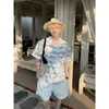 Camisa Casual Ligera Versátil de Moda Unisex Estilo Resort de Nicho Patrón de Olas Bloque de Color Hueca Verano 2026