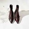 Invierno 2026 Estilo Nuevo Piel Suave Estilo Francés Punta Fina Hebilla de Cinturón Empalme Elástico Botas Ajustadas Botas Negras Cortas para Mujer