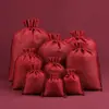 Bolsa de regalo navideña con cordón para guardar joyas, ideal para eventos transfronterizos.