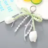 Nuevo Colgante Decorativo para Bolso Tulipán Dulce Cadena Colgante Versátil con Lazo de Perla para Funda de Teléfono Funda de Auriculares Accesorio