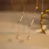 Agita el sonido de un collar de perlas multiusos para mujer, lujo ligero, nicho, Joker, alta sensación, cadena para la clavícula con forma de Y, venta al por mayor