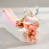 Llavero de aceite de botella de arena movediza acrílica, regalo al por mayor, colgante para mochila escolar, cuentas de colores bonitas, llavero colgante de arena movediza