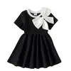 Comercio exterior transfronterizo Verano europeo y americano 26 nuevos modelos de elegantes vestidos de princesa negros con cuello redondo y lazo para bebés y niños pequeños, directo del fabricante