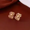 Pendientes de borla con flor de trébol de circonita vintage con un toque de alta gama, pendientes versátiles y de moda al por mayor
