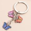 Llavero con colgante de mariposa de colores, gran oferta transfronteriza, accesorios creativos para bolsos, llavero pequeño de metal DIY.