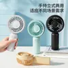 Mini ventilador mais vendido transfronteiriço, ventilador de mão portátil recarregável por USB com suporte de mesa, presente para estudantes atacado