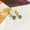 Aretes de diseño nicho de moda al por mayor transfronterizo europeo y americano, aretes colgantes redondos de acero de titanio, aretes simples de temperamento para mujer