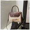 Textura elegante retro la moda de este año 2025 letras nuevo color combinación bandolera portátil hombro pequeño cuadrado bolso para mujer