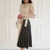Comercio exterior ropa de mujer 2023 Invierno nuevo estilo coreano elegante con cordones en la cintura de longitud media de punto con falda amplia mono suéter