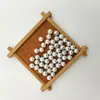 Perla de imitación de agujero medio de aguja única para resaltar el abdomen con accesorios de diamante colgante de perla suelta blanca hecho a mano para bricolaje al por mayor