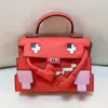 Bolsa Mosaico de Boneca Venda Quente Verão 2026, Bolsa Kelly, Bolsa de Mão com Design de Nicho, Padrão de Desenho Animado, Bolsa de Ombro e Transversal