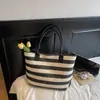 Bolsa de Palha Tecida Grande Capacidade Simples Bolsa de Mão Ombro Feminina Verão 2026 Nova Bolsa Tote Listrada Feminina Atacado