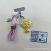Crachá Logo Sanrio Chaveiro Buquê Pingente Bolsa Dourada Ornamento para Corrente de Celular Pingente Pequeno Sanrio