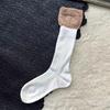 Calcetines de mujer otoño e invierno nuevos calcetines de doble capa con costuras personalizadas calcetines de felpa de nicho calcetines de punto doble de color contrastante para pantorrilla
