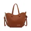 Bolso de cubo de mano estilo coreano popular para mujer de este año, nueva llegada Otoño 2026, color liso, simple, bolso de un solo hombro, para el trabajo, bolso cruzado