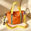 Bolso cubo transfronterizo nuevo, bolso pequeño ligero y casual de moda para exteriores, bolso de hombro cruzado versátil con bloques de color para el trabajo