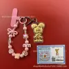 Llavero de tela con logo de empresa personalizado Cadena para teléfono móvil Angela Lámina de oro puro Oro 999 Regalo de aniversario