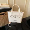 Bolso tipo cubo de moda de diseño minimalista de nicho estilo coreano transfronterizo, nuevo bolso de hombro y bandolera para mujer Primavera 2026
