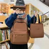 Mochila casual de color sólido simple multicapa de comercio exterior nuevo conjunto de tres piezas para estudiantes de primaria y secundaria