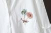 Nova camisa solta de lapela com bordado de flor de bolso fresco artístico e retalhos nas mangas - Coleção Primavera 2023