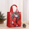 Bolsas de tela navideñas transfronterizas, bolsas de regalo, bolsas de tela temáticas de Santa Claus, bolsas de tela de Nochebuena, bolsas de tela coloridas de tela no tejida, en stock