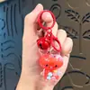 Colgante llavero Sanrio acrílico relleno de aceite, botella de arena líquida linda arcade, regalo pequeño de dibujos animados para estudiantes al por mayor