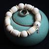 Um grande número de pulseiras de contas de Buda de dente de hipopótamo de resina por atacado, estilo pulseira cênica de shopping center, atacado